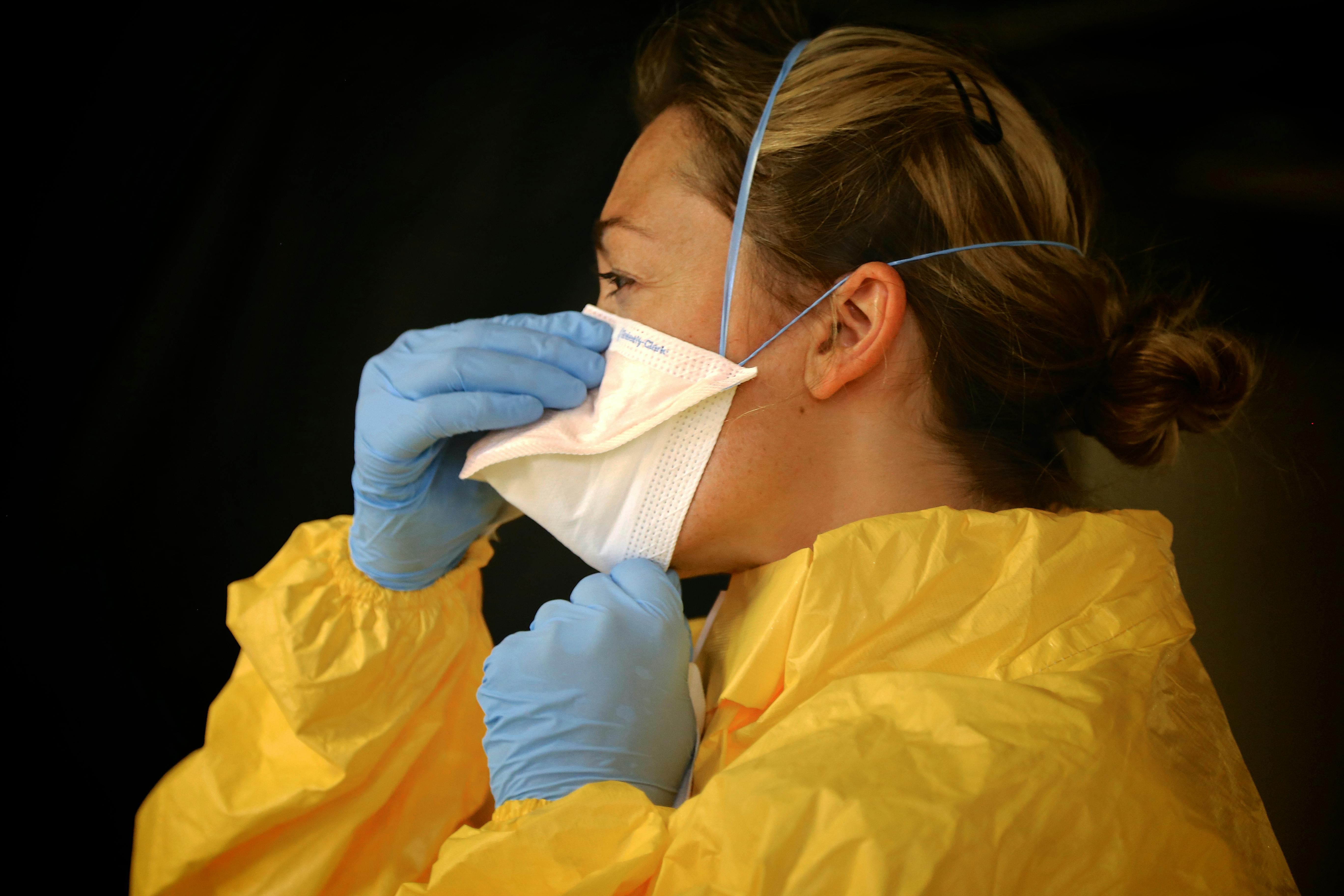 a nurse putting on her ger